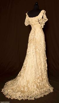 TRAINED IRISH CROCHET GOWN, c. 1908 / Cap sleeve, low rounded neckline front & back, fitted through high waist, very full trained skirt, small, large & 3 dimensional crochet flowers & foliage, cream satin built in boned lining, waist tape stamped "TRAVERS, 106 E. 58TH ST, NY", B 32", W 22",FL 59", BL 76",