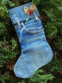 This Christmas stocking is made with recycled blue jeans and has a tie ...