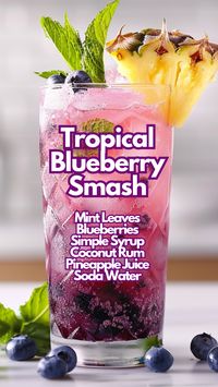 If you are craving for a refreshing and fruity drink, the Tropical Blueberry Smash is a perfect mix of blueberry, mint, and lime with a splash of coconut rum and pineapple juice. This cocktail is topped with soda water, creating a perfect balance of sweetness and fizz. Garnish with fresh fruit and mint for an eye-catching presentation. #tropicalblueberrysmash via @mybartender