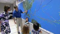 At the National Weather Service and Hurricane Center, Penny and the KidVision VPK kids learn how to read world weather maps, track hurricanes, predict the weather, and practice reporting on television.