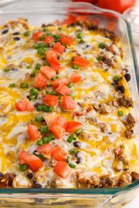 Easy, cheesy Mexican lasagna is made with a seasoned beef mixture that's layered between corn tortillas and a blend of jack and cheddar cheese then baked until bubbly in a casserole dish.