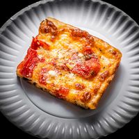 The Grandma pizza consists of a sheet pan style pizza baked with mozzarella, plum tomatoes, fresh garlic, Pecorino Romano, and oregano.