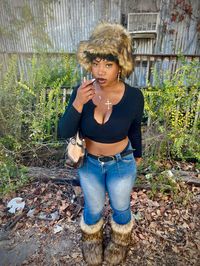 fur boots, fur hat, black girl fashion, y2k, early 2000s, aesthetic, fashion, fashion inspo, photoshoot, lightwash jeans, cross necklace, gold jewelry