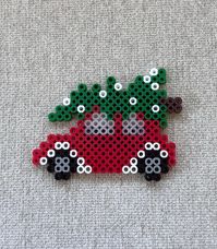 Christmas car perler bead magnet made with red, green, white, black, gray, clear and brown beads.