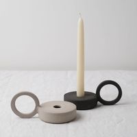 Ring candle holder hand made with textured black stoneware and left unglazed, by Studio Brae. Ring candle holder in textured black stoneware. This bold unique ceramic candle holder is handmade in Edinburgh and features textures and details from the making process and is hand stamped at the base with the makers mark. Hand thrown on the potter's wheel, the finishing process reveals unique textures within the clay body. • hand thrown in Edinburgh, Scotland • all pieces are individually handmade • d