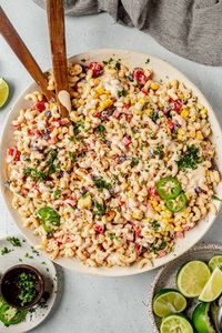 If you're a fan of Mexican flavors, you've got to try this Mexican macaroni salad recipe. It takes a classic macaroni salad and adds authentic Mexican flare with roasted corn, black beans, bell peppers, and the best creamy Mexican dressing. It's easy to make and goes with everything! Add chicken or ham for extra protein.