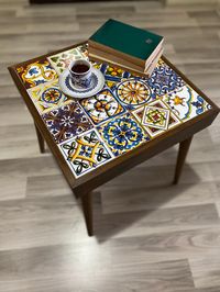 This coffee table, created in harmony with ceramic and wood, can create a wonderful corner in your home, office. The coffee table is made of pine wood. Feet come disassembled. It is very simply rotated and tied. There are 16 pieces of 10x10 cm ceramic on it. The upper part of the coffee table is 43X43 cm together with the wood. The depth of the coffee table with its legs is 48 cm. The colors may appear slightly different because of the lighting conditions, camera, etc. settings. If you have any questions regarding the description of the product, feel free to ask me. Small differences are in the nature of handmade work. Please read my policies before purchasing.