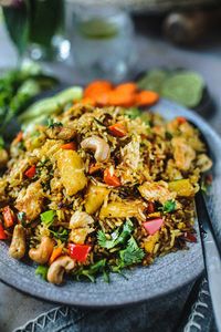 Thai Pineapple Fried Rice holds all the Thai flavors of spicy, sweet, and salty with a perfect tang from the pineapple and tops off with a crunchy, nutty taste of cashew. Make it with chicken or tofu.