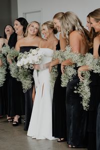 Baby's breath garlands as bridesmaid bouquets Floral Shawls black and white industrial modern romantic wedding at Glass House in Minneapolis