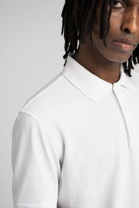 Debuted on the tennis courts of the 1920s, The Pique Polo shirt fills the space between the shirt and the T-shirt. First introduced in our permanent collection in 2016, this is our fifth version update: At its core is a custom developed soft and substantial, breathable organic cotton knit. Our straight cut silhouette is embellished with a perfectly balanced collar and a seamless French placket with our signature, tonal mother of pearl buttons.