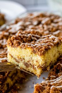 Sour Cream Coffee Cake, with a Ridiculous Amount of Streusel from The Food Charlatan. This is my FAVORITE recipe for Sour Cream Coffee Cake! My main complaint with Coffee Cake is that there is usually too much cake, not enough streusel. This recipe gives you the max amount of streusel without ruining the light fluffiness of the cake! A vanilla drizzle finishes it off! #coffeecake #sourcream #icing #frosting #drizzle #easy #recipes #cinnamon #streusel #sourcream #crumb #crumble #moist #breakfast