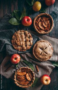 Apple pies with different decorations by Nataša Mandić for Stocksy United