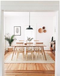 Who else is loving @thecuriousnatalia's dining room? 🙋 It's laid-back enough for takeout on a Friday, but classy enough for wine + a cheese board on a Saturday. Tap to shop our Clarence Dining Chair, then share your space with #itsallmodern.