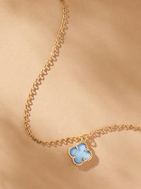 Simplicity in design but elegant in its statement, this 14K gold clover charm necklace is timeless in your jewelry box. Featuring a light blue clover charm outlined in gold and displayed on a dainty gold chain, this necklace creates an aura of beauty radiating from within and encapsulating its wearer.