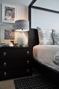 A black Malm dresser with pretty ring pulls is a chic nightstand for a bedroom