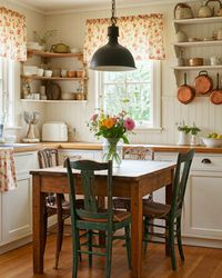 Transform your kitchen with farmhouse charm! Think open shelving, vintage copper pots, and a small wooden dining table. This rustic kitchen will bring the countryside into your home. #FarmhouseKitchen #RusticHome #CountryLiving