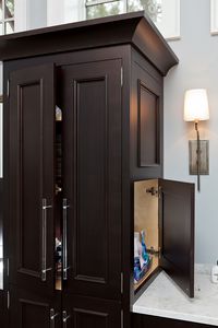 A unique bathroom cabinet built by Eastburn Woodworks to keep your toiletries hidden and your counters clear and clean. #CustomCabinets #Cabinets #Bathroom #MasterBath