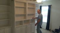 Rick is doing the demonstration of the operation of a Sliding Library Murphy Bed. Turn a spare room into a guest room and library with this all-in-one Murphy wall bed hidden behind the sliding library bookcase. Visit our showroom, come say hello to Rick the owner and master craftsman, give us a call or send us an email to discuss your next furniture or cabinet project. Schedule your FREE in-home consultation today! Traditional Sliding Library Bookcases with Savona Murphy Bed Wall Bed, Nightst