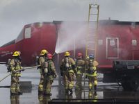 Phoenix Fire Department firefighters practice a rescue during airport disaster training on Tuesday, March 24, 2014, at the Phoenix Fire Training Academy 2425 W. Lower Buckeye Road.