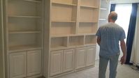 Rick is doing the demo of the operation of a Sliding Library Murphy Bed. Traditional Sliding Library Bookcases with Savona Murphy Bed Wall Bed, Nightstand Openings, 3" Crown Molding, 2 Piers, 2 Bookcases with Raised Panel Doors n Whitewash on Oak – Queen 138"w x 92 5/8"h x 28"d. Visit our showroom, come say hello to Rick the owner and master craftsman, give us a call or send us an email to discuss your next furniture or cabinet project. Schedule your FREE in-home consultation today!