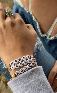 Add a playful touch to your accessory collection with the Howdy Yeehaw Bracelet Pack. Featuring fun and vibrant alphabet beads, these bracelets spell out "Howdy", "Rodeo" and "Yeehaw," perfect for expressing your western spirit. Wear them solo or stack them for a bold statement. Set includes all three bracelets.