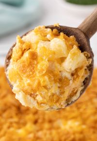 Scoop of potatoes on a wooden serving spoon