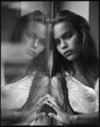 "Angel or Demon" by Kevin Williams with Pentax 67 on 120mm Kodak Tri-X film. filmisnotdead. black and white woman reflected in the glass. tan skin and soft light. simply soft.