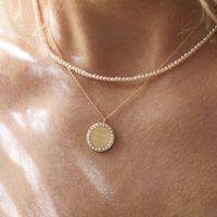 Tiny Pearl Necklace and Pearl Halo Pendant by Berlinger