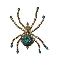 Beautiful, sparkling,Rhinestone, spider Christmas tree decoration.  A copy of the Legend of the Christmas Spiders is included. Add a touch of elegance to your Christmas tree with this handmade turquoise and silver rhinestone spider ornament. The intricate design and attention to detail make it a perfect addition to your collection of holiday decorations. The ornament measures 3 inches in height and 3 inches in width and features decorative features that will make it stand out on your tree. Perfect for any occasion, this ornament will add a unique touch to your holiday decor.