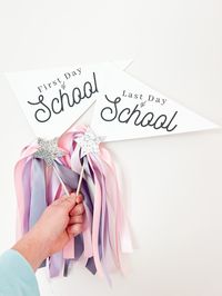 This listing is for a set of two pennant flags. One for the first day and one for the last day.  These are printed on extra heavy cardstock, attached to a wooden rod and embellished with ribbons.  Default saying will read "first day of school" and "last day of school" as the photo shows. You CAN customize details  * grade (include this in the buyers notes right before check out)  *ribbon color *embellishment star color   *AS OF 5/10/23 YARN IS NO LONGER INCLUDED AS IT'S NO LONGER AVAILABLE FOR M