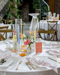 Texas Florist | Bobbi Padgett | you kidding me 🥲 these pastel tapers added so much to this tablescape!! A sweet bud quartet paired with a trio of taper candles is one of... | Instagram