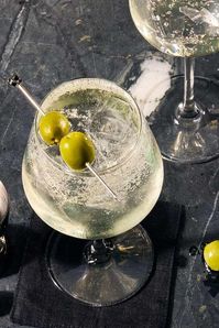 This effervescent play on a Dirty Martini combines everything you know and love about the classic high-proof cocktail, but makes it a whole lot more refreshing. Gin and vermouth combine in a big wine glass and get topped with club soda in this light and bright spritz.