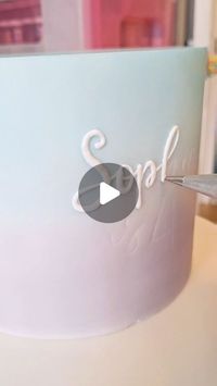 Holly Bordon | SW London & Surrey on Instagram: "~ Handpiped Lettering ~
Pressure piping is my favourite way of putting text on to cakes now and I thought I'd show you how I like to do it. 
I wasn't able to pipe vertically for a really long time but 11 years of practice has finally paid off 🙌🏻

I've been thinking a lot about what people might like to learn from me, if anything, and this might be a good one to start with. Would you like to see this in a tutorial?
Let me know! 👇🏻

_________________________
#cakereelsvideo #cakereel #cakereels #handpiping #royalicing #hollydollycakesuk #surreycakes #surreybaker #caketutorial #caketutorials #lettering"