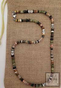 "Excellent beading in this earthy necklace. This piece was designed using green jade gemstone and jasper gemstone with complimentary beads. There is a feel and look of many cultures in this necklace so we had to name it \"multicultural.\" The forest and earth are represented by beads of green, brown and beige. The small bone skulls add to the atmosphere of this necklace.   We use quality materials in our designs such as a good grade gemstones and stainless steel wire and clasp.  Because our jewe