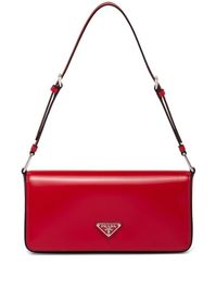 red leather brushed effect enamel triangle logo silver-tone hardware adjustable shoulder strap foldover top with press-stud fastening This item is made from at least 50% recycled or upcycled materials. For recycled synthetic clothing products, we highly recommend using a microfibre-catching washing bag to ensure that no microplastics that can pollute water are released in the process. Learn more about what makes a product Conscious on our Conscious Criteria page