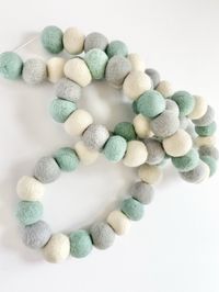 Wool Jamboree felt ball garland is perfect for seasonal decorations, fireplace decor or celebration party decor! You can hang it on your mantel, wall, window, doorway, or flowing throughout your seasonal tiered tray or letterboard! Colors: turquoise, smoke, white - repeat If you would like to swap a color, let me know of the swap in the "Personalization" section of this listing.Made of 2 cm felt wool balls on white cotton cord.Three styles to choose from:1. Spaced out felt balls - 4 felt balls p