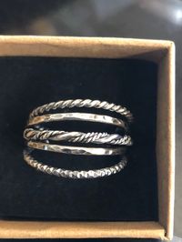 Like your stacking rings to have a more substantial feel? This set is sure to please as it contains five 14 and 12 gauge textured bands you can mix and match. This Sterling Silver ring set includes 5 Sterling Silver Stacking Rings. One rope band, Two hammered bands, one diamond cut band and one rope and smooth silver twisted band. I've hammered and oxidized this set. Tumbled for hours and polished...Just a beautiful combination of texture! With this set you will want to size up a half size to gi