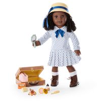 Claudie will be ready for her family road trip with a new outfit and a 1920s-style suitcase filled with travel necessities. This set features:  Claudie's™ Travel Outfit for 18-inch Dolls: A white long-sleeved midi dress with an allover navy polka-dot pattern, a straw hat with a navy-blue ribbon, and tan lace-up boots with white socks  Claudie's™ Travel Accessories for 18-inch Dolls: An authentic 1920s-style brown suitcase, a pretend bar of Madam C.J. Walker perfumed soap and a tin of Madam C.J.