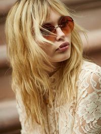 The model wears oversized brown shades for the perfect summer accesory