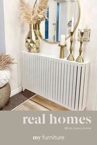 Feel the heat, no need to see the radiator. @ivys_luxury_home 📸👈. Our ANASTASIA radiator cover is luxurious featuring hand-cut, bevelled white glass panels, completed by a stainless-steel pedestal with a brass finish. Carefully proportioned to function secondarily as a console table, creating an additional storage and display surface. FREE DELIVERY UK MAINLAND. We deliver throughout Europe #radiatorcovers #hallwayideas #livingroomideas