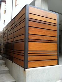 A unique combination of stained Mangaris lumber and Kynar-painted steel posts defines this Manhattan Beach, California fence from Ecocentrix Landscape Architecture.