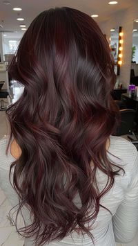 Elevate your dark brown locks with a pop of rich Burgundy Highlights, adding depth and dimension to your mane. This stunning combination exudes elegance and allure, making a bold statement with every strand. Discover more captivating Dark Brown Hair Color Ideas in our article and unlock the secret to timeless beauty. #BurgundyHighlights #DarkBrownHair #HairColorIdeas #DimensionalColor #FollowUs