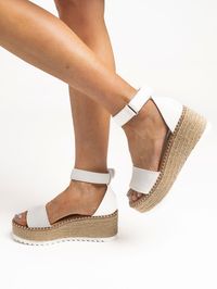 This MOD fave is back just in time for all your summer plans! Wear the "Next Level Espadrille Wedge Sandals" with a basic tank, flowy pants, and sunhat for a cute brunch look. For a pool day with friends, add these boutique sandals to your favorite swimsuit coverup, denim shorts, and sunglasses! PRODUCT DETAILS: White Espadrille Wedge Sandal Faux Leather Toe & Ankle Strap Velcro Ankle Strap Closure Thick Espadrille Platform White, Ridged Bottom SIZING INFORMATION: Runs True To Size! SHIPPING AND