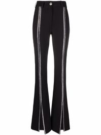 Black Cady high-waisted trousers from PHILIPP PLEIN featuring silver-tone stud detailing, skull stud embellishment, high-waisted, belt loops, concealed fly and button fastening, two side slit pockets, two rear welt pockets, front slit and flared hem. | Philipp Plein Cady high-waisted trousers