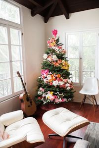 These Christmas tree themes will give you ideas for a much-needed update in your home's holiday decorations department. From classic to minimalist — and even to Disney — there's sure to be a theme to match your style. Your holiday guests will be in awe (and jealous) of these Christmas tree themes. #christmastreethemes #christmastreedecorations #floralchristmastree #southernliving