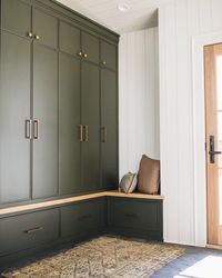 Mudroom with olive green built-ins and vintage rug