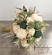 "Model SGGR24 ABOUT THIS ITEM: This wedding flower package is made with natural Sola flowers, Sage color, Eucalyptus green and Cream Roses, Mini Roses, Beli Flowers, Cranations, Dried Baby's breath, Faux Pampas. The handle is decorated with Burlap . Other pieces match bride's bouquet. Bride's bouquet shown in first picture is the 10\" size. ABOUT SOLA FLOWERS: Sola wood flowers are made from Shola plant. Each individual sola wood flower is handmade. The natural color is ivory, but they can be dy