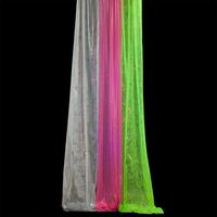 Gossamer products are not returnable or refundable. NOTE: Please allow 48 hours for production of all fabric products.   The kit includes one roll each of pink, green, and silver gossamer that measure 59" wide x 25 yd long. Drape or hang these brightly-colored gossamer cascades from the ceiling, add a neon light (not included) and your dance floor is sure to come to life. Gossamer is a non-woven, sheer, lightweight and versatile decorating material. For a more opaque look, you may layer the fabr