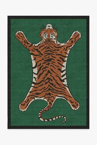 Wild cat chicness. Our Jonathan Adler Tiger Emerald Rug features an orange, cream, and black tiger sprawled across a rich emerald green background with a needlepoint texture across the design. Made from our water-resistant, stain-resistant, and machine-wa