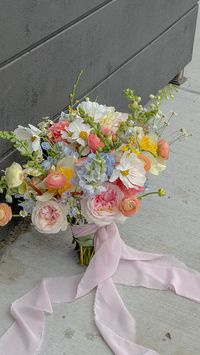 Colorful bouquet in peach, light yellow, baby blue, blush color palette. Perfect summer wedding inspiration